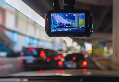 A dashcam records heavy traffic ahead from a vehicle's windshield. dash camera footage