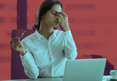 woman behind a laptop visible tired