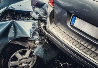 Severely damaged blue car crashed into the back of another.