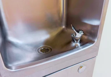 Close-up view of a clean stainless steel drinking fountain basin.