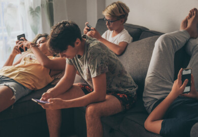 97061505-young-man-using-mobile-phone-home